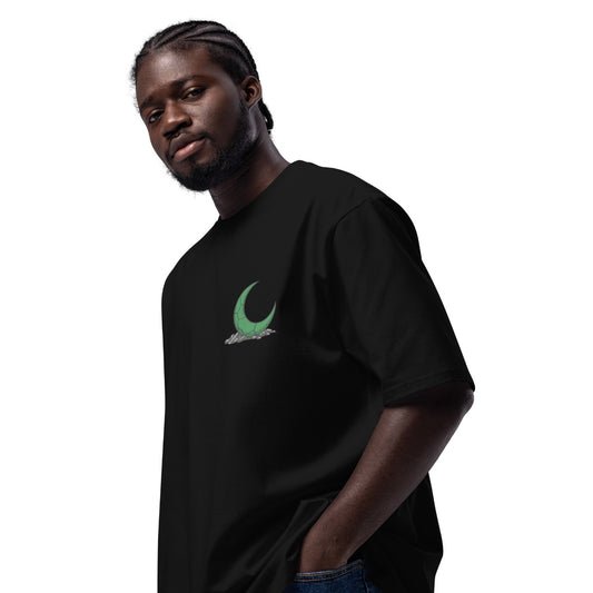 Man wearing a black t-shirt with a green graphic on a white background
